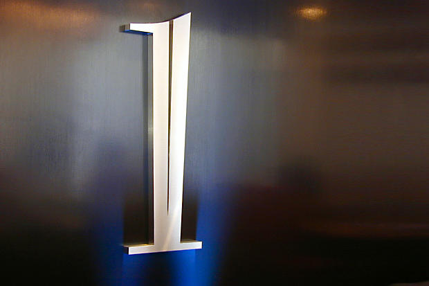 Stainless steel business 3D logo lobby signage for condo and hotel building reception area made by Art Signs Company