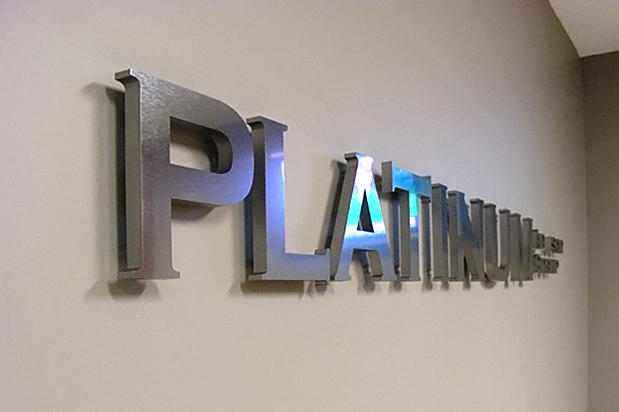 3d dimensional corporate office lobby reception signage and logo sign lettering raised off the reception area wall on spacers