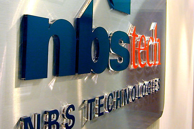 3D office sign with push through dimensional color acrylic letters on brushed stainless background in lobby reception area