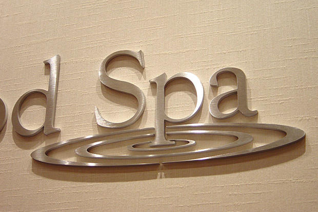 3d stainless steel metal metal wall sign as signage system installed on the wall