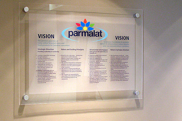 Parmalat vision and mission statement signage on acrylic glass panel with custom vinyl graphics raised on stainless steel mounts