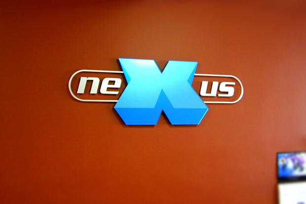 Office lobby sign made with individual dimensional acrylic signage lettering and logo as branding on business reception area wall