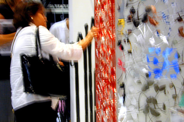 Interior designer touching decorative laser cut panel at IIDEX Interior design show 2007 in Toronto - Art Signs Company.