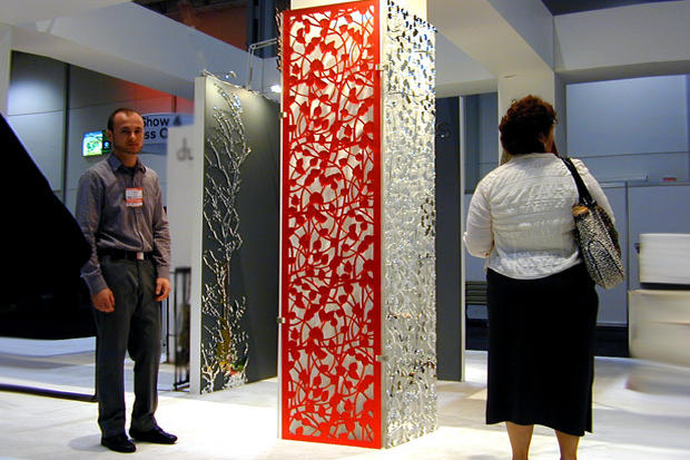 Sales person presenting decorative laser cut screens and panels for interior decoration in home and office at iidex Canada - Art Signs Company