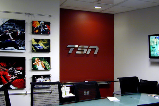 Boardroom office signage for TV station TSN made using metal film on laser cut acrylic in business boardroom - Art Signs Company