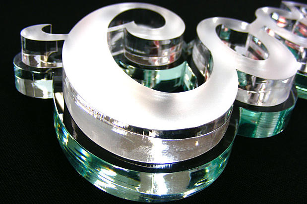 3D Coors Light office lobby signage made with laser cut acrylic sign lettering on decorative stone wall in reception area with decorative wall hooks,