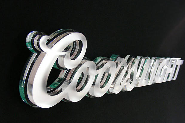 Laser cut acrylic Coors Light signage lettering on decorative stone wall with decorative wall hooks