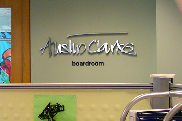 Raised dimensional laser cut metal letters for office lobby directional signage