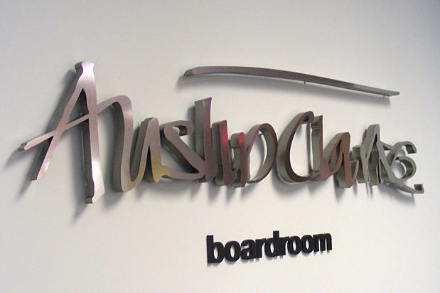 Decorative office lobby wall sign with raised metal letters for business boardroom