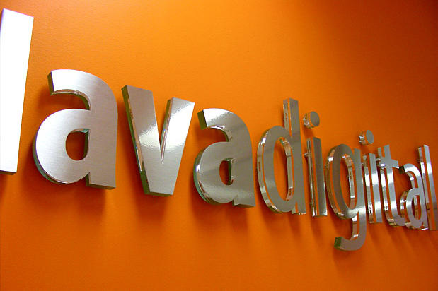 Lavadigital Corporate logo sign with brushed metal finish to match and stainless steel look with wall installation in waiting area. Sign made by Art Signs Company