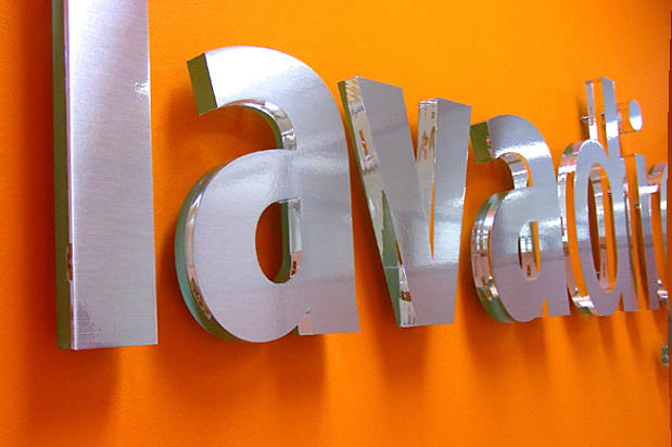 Lavadigital Corporate lobby sign systems with brushed metal finish raised off reception area wall. Sign made by Art Signs Company