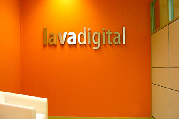 Lavadigital raised metal corporate logo signage lettering in lobby reception waiting area. Signage made by Art Signs Company
