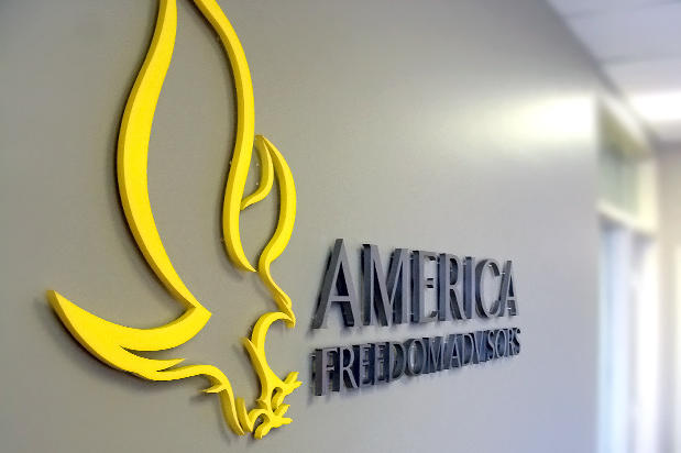 Painted laser cut 3D business lobby sign logo raised on reception area wall. Sign made by Art Signs Company