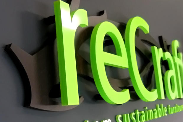 Raised dimensional exhibit signage lettering mounted to sign background panel as portable show plaque made by Art Signs Company