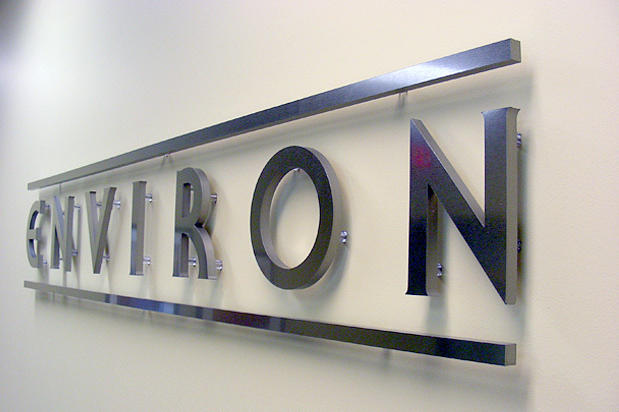Raised pin mounted dimensional metal signage letters as office lobby sign in main reception area made by Art Signs Company