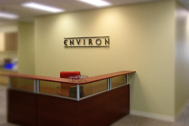 Business logo word mark signage design idea mounted behind lobby reception desk made using laser cut acrylic sign lettering by Art Signs Company