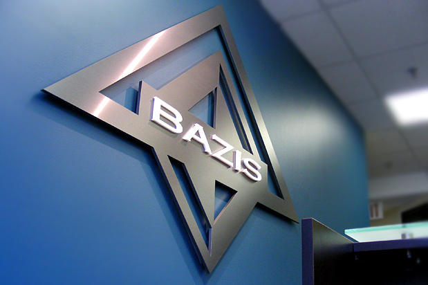 Metal finish lobby signs raised off the reception wall on spacers