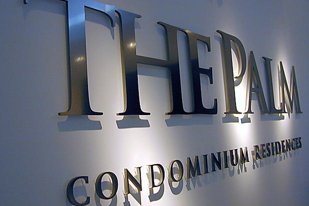 The Palm Condominium Residences reception area lobby signage with individual metal sign lettering raised off the wall on spacers