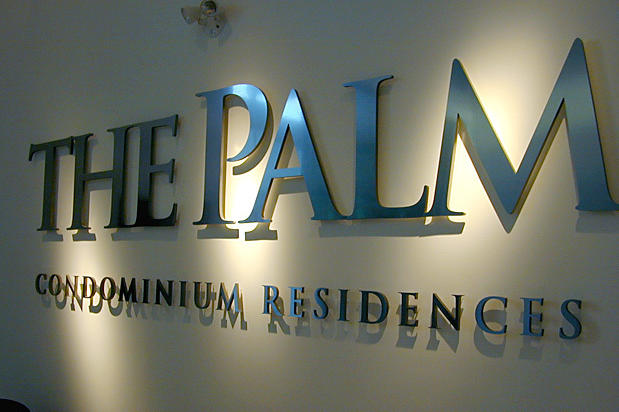 The Palm Condominium Residences, condo sales presentation centre reception area wall mounted lobby signs behind desk