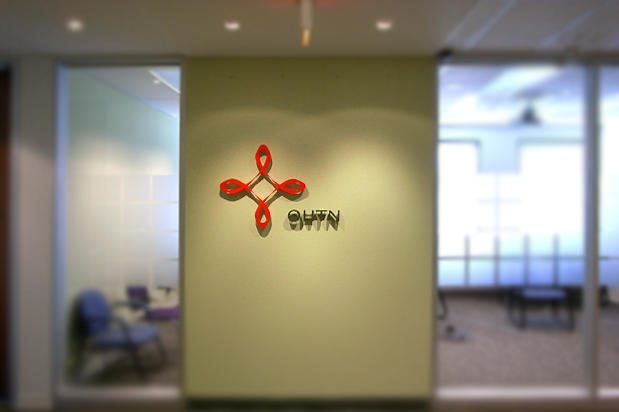 3D Office lobby signs made by Art Signs Company raised on waiting room wall and illuminated by halogen spot lights