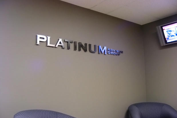 Metal signage lettering raised off reception waiting area wall made by Art Signs Company Toronto