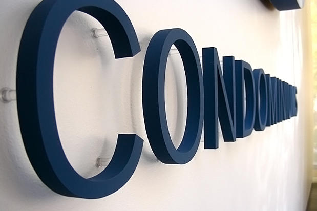 Decorative 3d metal lobby signage lettering raised off office reception area wall on spacers