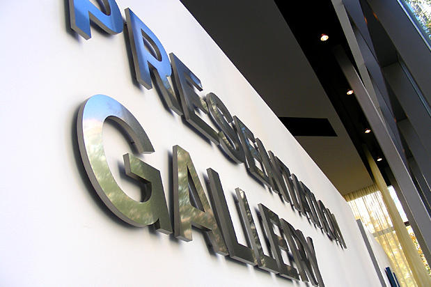 Metal lobby signage design for condo sales center presentation gallery