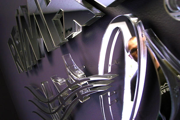 3d sign office reception area made with mirror acrylic and raised off lobby wall by Art Signs Company