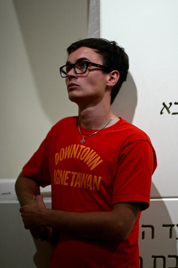 Adam D. sign installer watching, Adam D. looking at the installation at Royal Ontario Museum, Donor Walls project