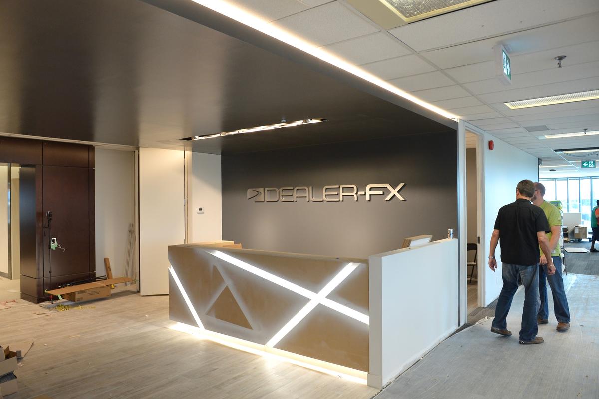 3D reception sign with LED lit office desk and people standing next to sign