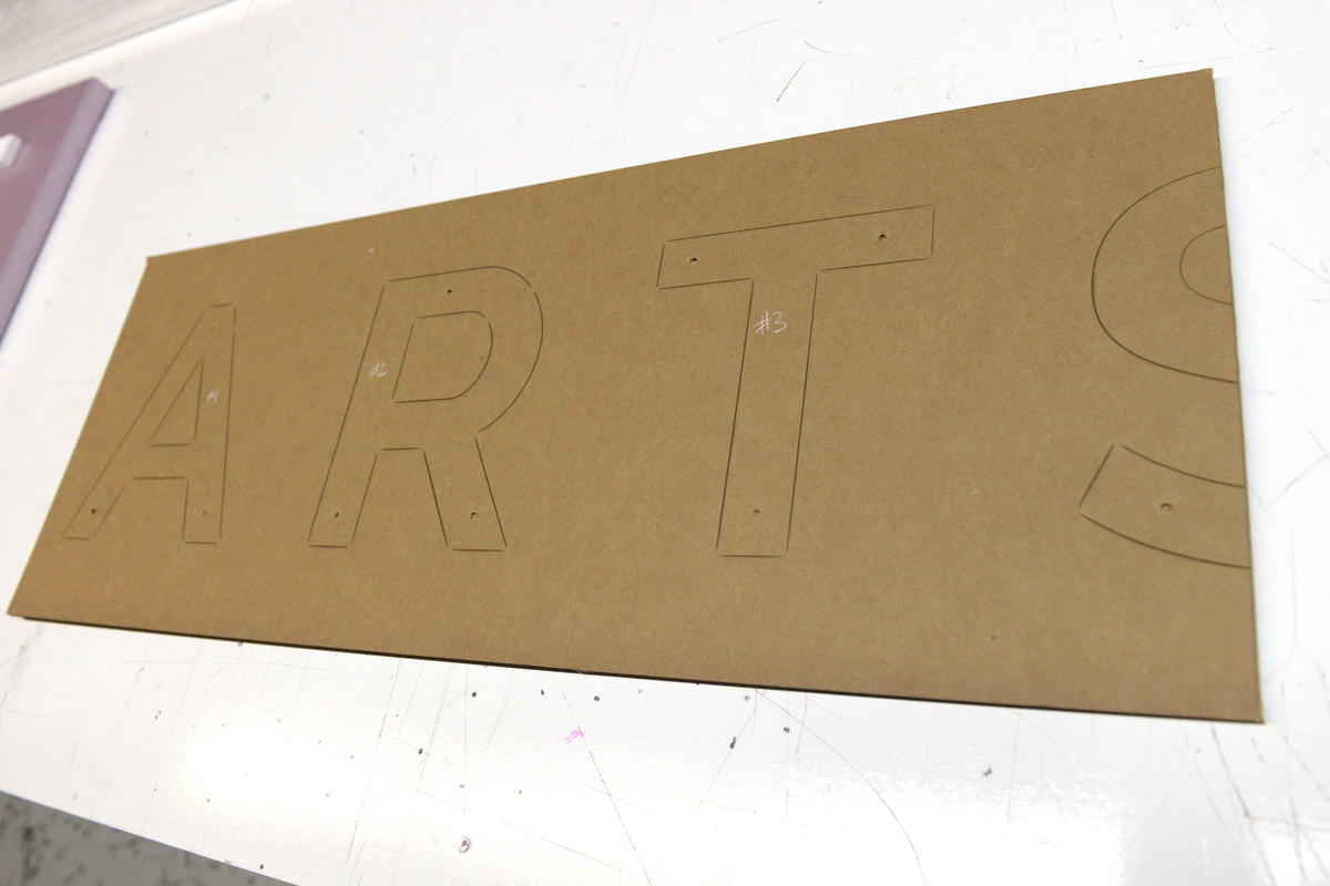 Laser cut outlines on cardboard installation template.