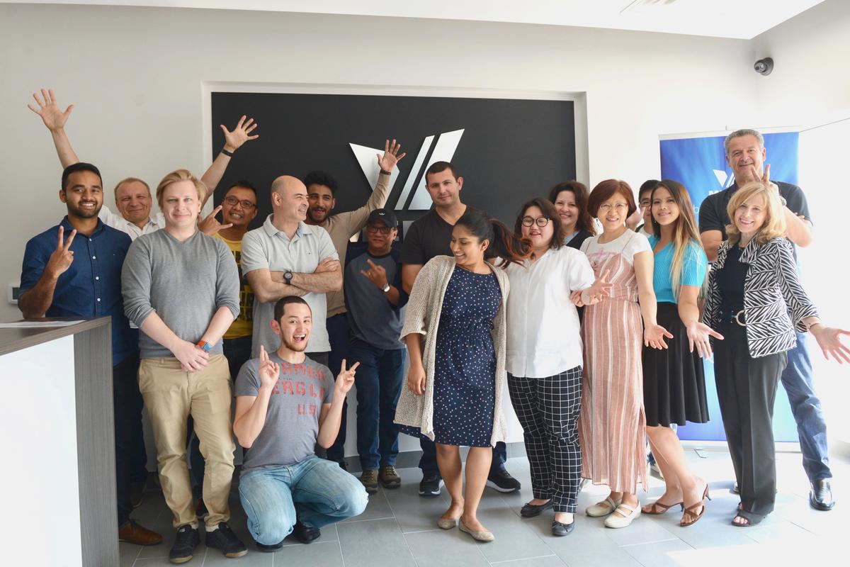 Customer group photo by Reception area wall sign for Vmedia made by ArtSigns