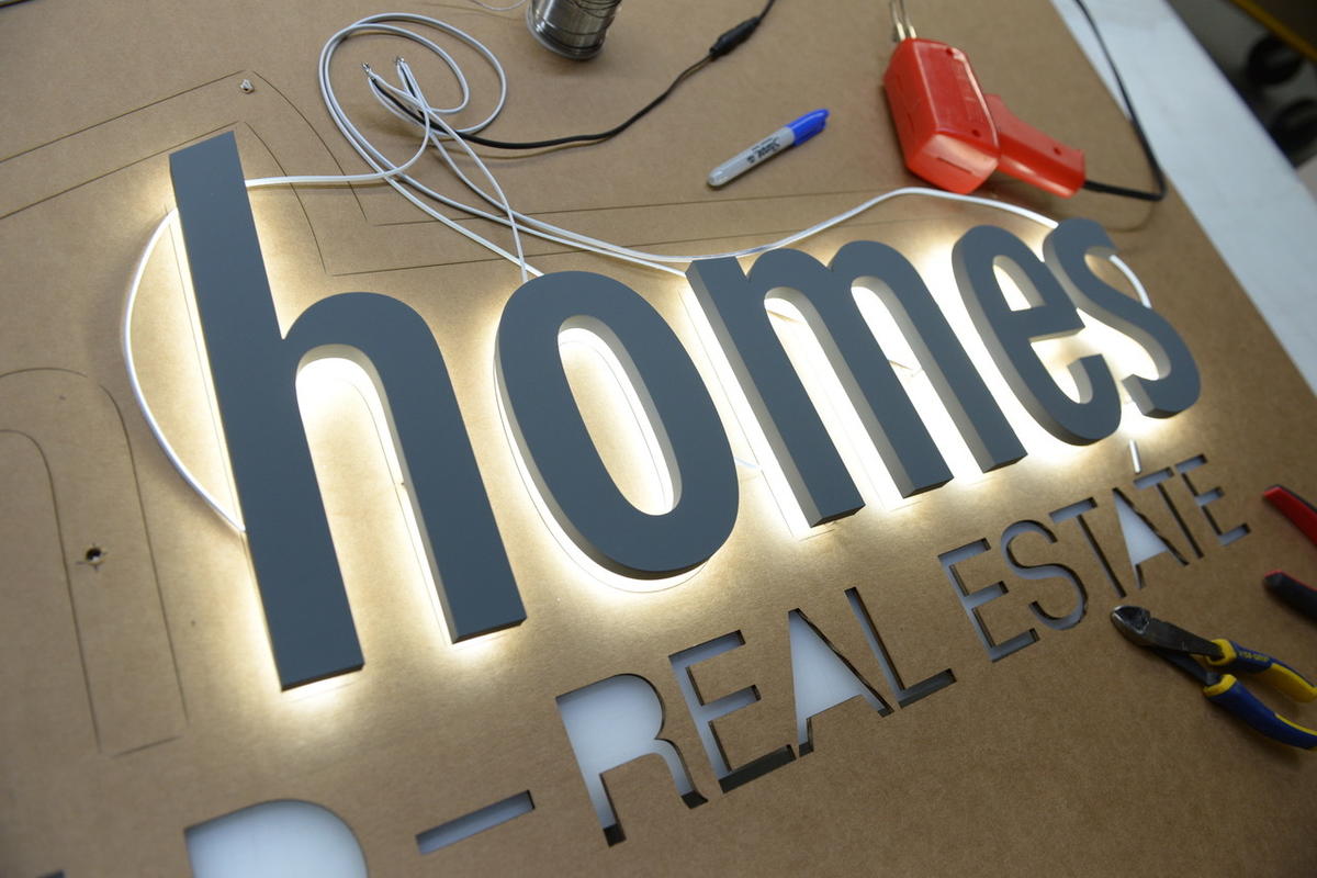 Backlit letters and mounting template with cables, and tools