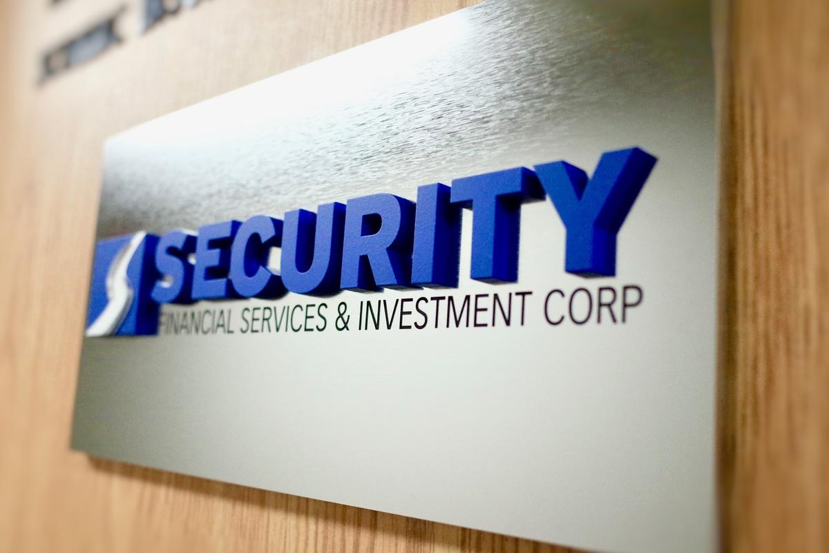 Engraved corporate financial services office sign with 3D letters painted blue Security Financial