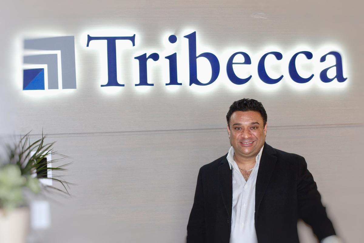 Rajan Kaushal of Tribecca with ArtSigns Backlit Logo Wall Sign pre-mounted to Wood Veneer Panel