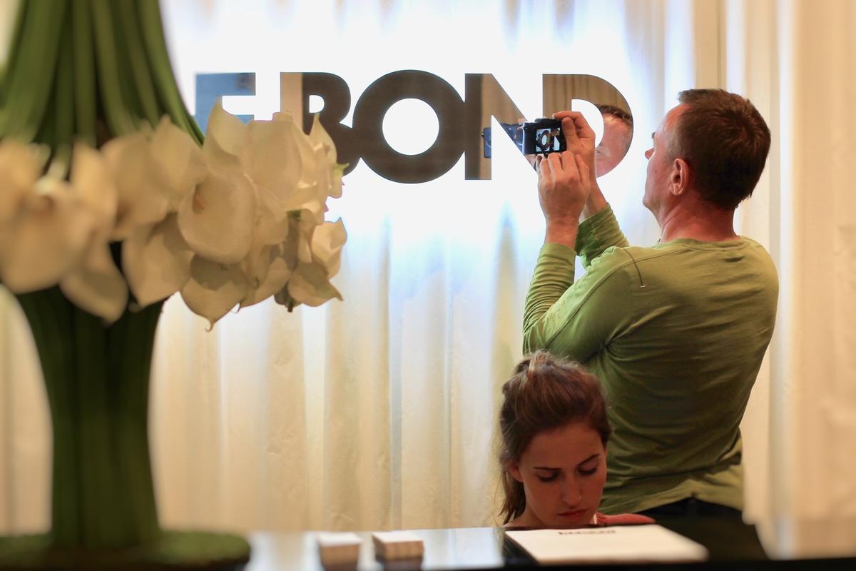 Chrome Backlit Sign mounted raised through reception desk area drapes at sales center