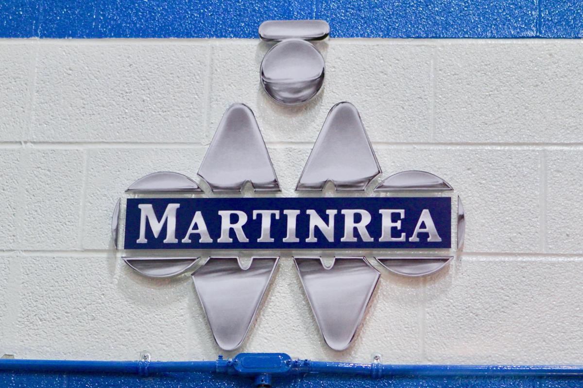 Custom 3D Sign with chrome logo raised off factory cinderblock wall