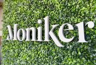 Custom business sign logo cut out on green wall in office space reception area