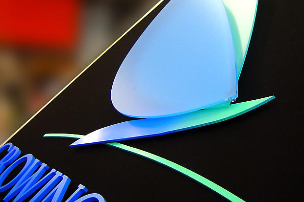 Closeup of custom office sign made for corporate business with layered dimensional acrylic logo and lettering