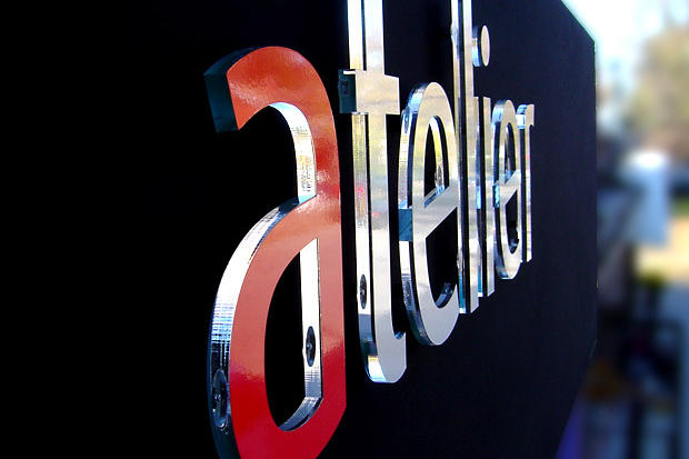Exterior dimensional lettering on retail store sign Atelier