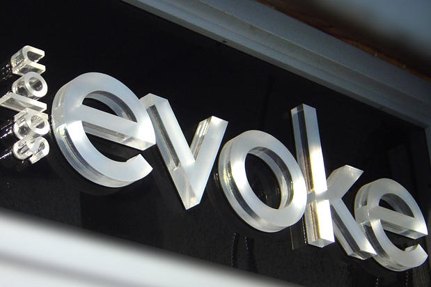 Salon Evoke 1" Thick frosted acrylic hair salon letters on glossy black acrylic panel
