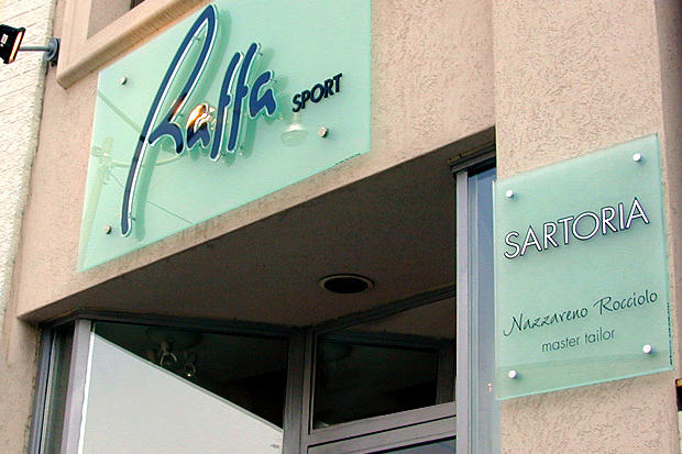 3D acrylic retail plaque sign installed on the wall with stainless steel decorative caps