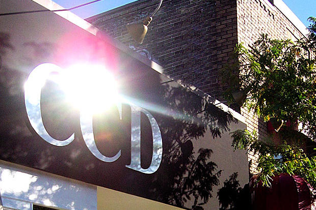 3D corporate logo sign made of dimensional laser cut acrylic letters with stainless steel finish reflecting light