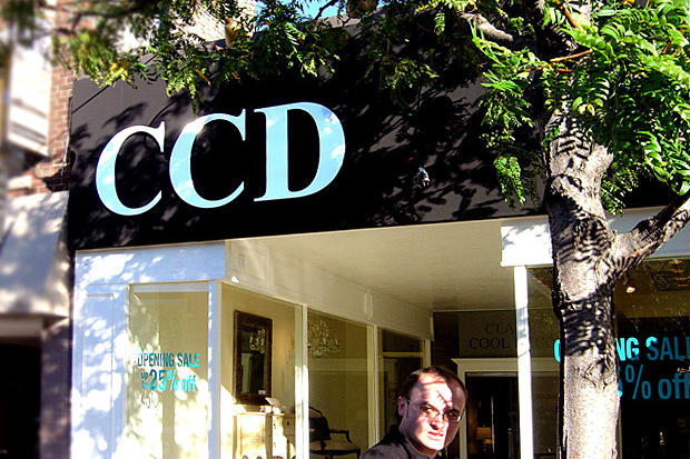 Retail business sign with dimensional acrylic letters and custom vinyl film graphics on the window