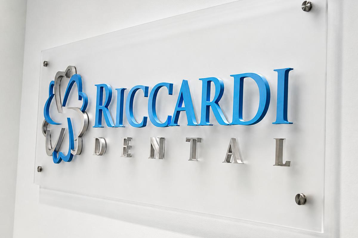 Frosted acrylic panel sign with 3D acrylic and metal cutouts
