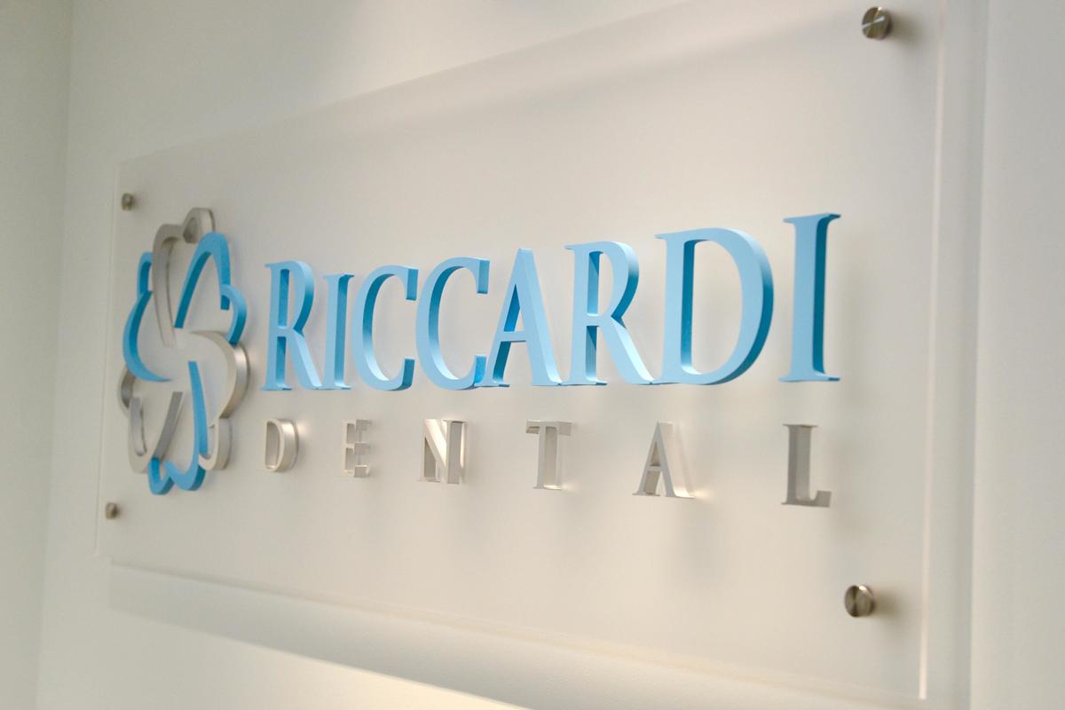 Frosted acrylic panel sign with 3D acrylic and metal cutouts