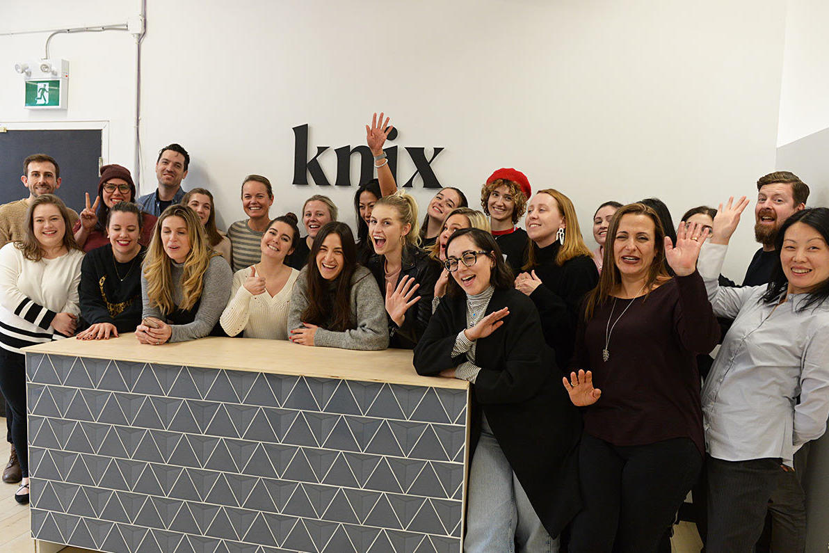 A lively group of Knix Canada team members gathered in front of their custom reception sign by ArtSigns, showcasing the brand’s commitment to comfort and confidence with period underwear and body-positive essentials.