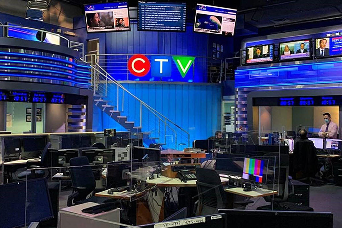 Illuminated CTV News sign installed in a modern newsroom, featuring a bold red, blue, and green design. The newsroom is filled with workstations, monitors, and broadcast equipment, showcasing a professional media environment.