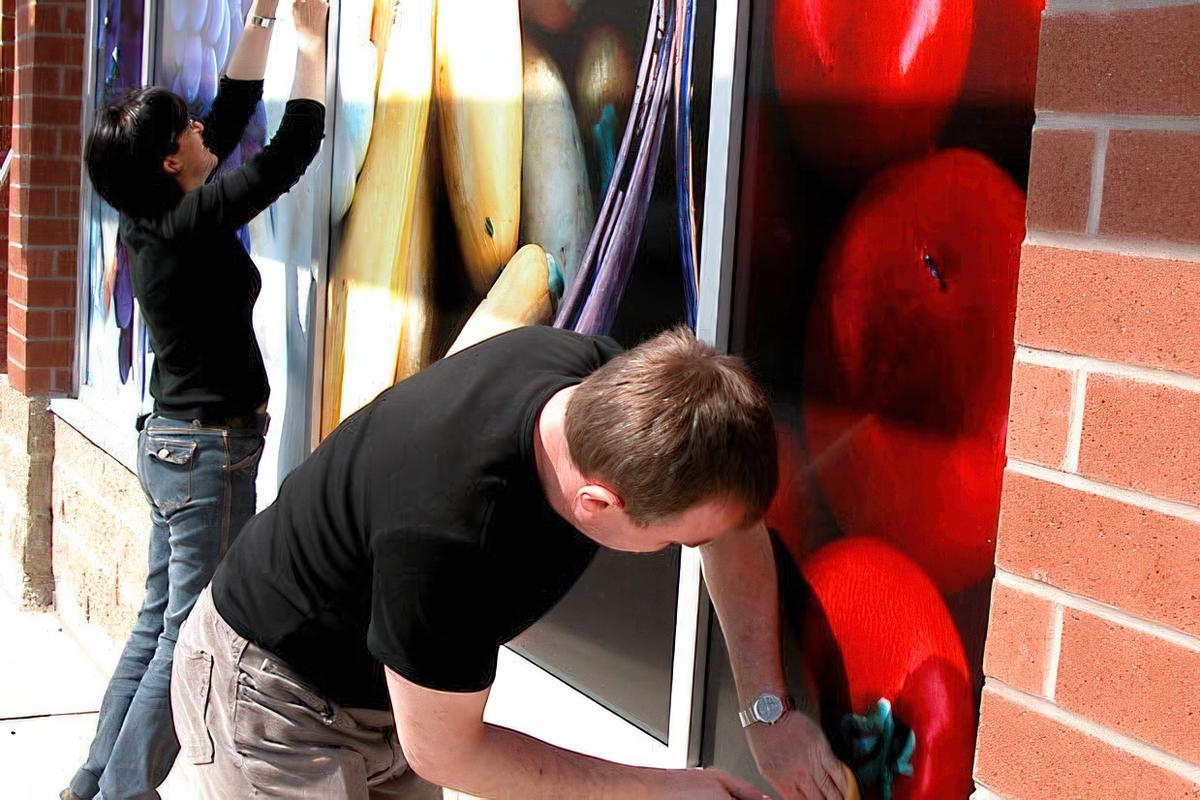 Printed vinyl window graphics with UV laminate applied to Whole Foods Oakville storefront windows for branding and durability.
