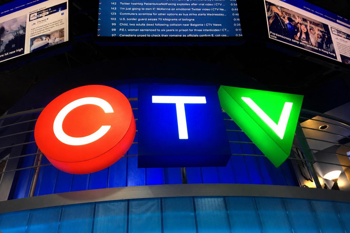 Close-up of illuminated CTV acrylic logo sign with red blue and green shapes